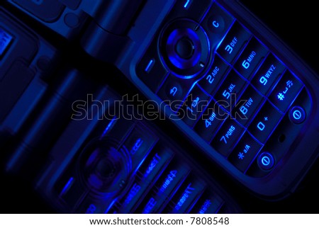 Close Shot of Cell Phone In Deep Blue On Reflective Surface