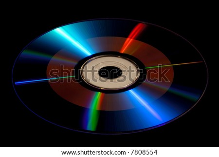DVD / CD-ROM Disk Isolated on Black, With Radiating Prismatic Rays of Light
