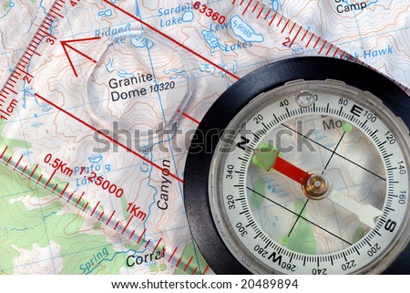 Transparent Navigational Compass on Topographical Map, Needle Pointing to Magnetic North