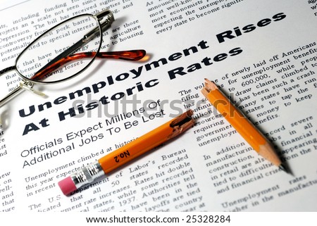 Fictitious article describing rising unemployment, glasses, broken pencil suggests fallen spirits