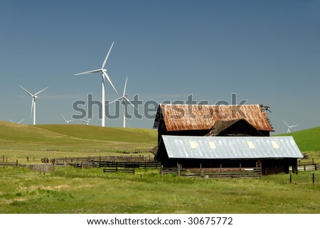 Stark White Electrical Power Generating Windmills, Turbines on Rolling Hills of Green and Ranch Old Barn Wildflowers, Rio Vista, California