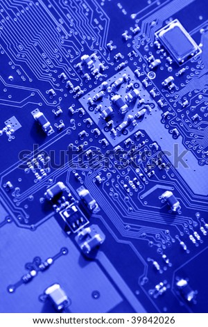 Blue macro of printed circuit board patterns and electronic parts, selective focus according to rule of thirds.