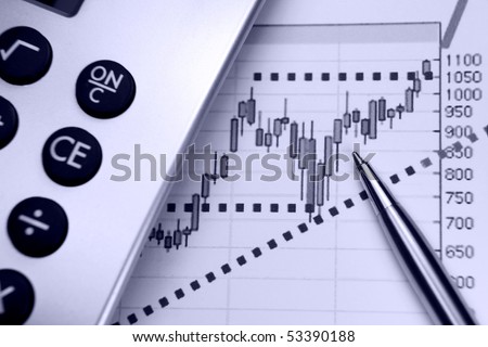 Financial chart, market\'s rising, calculator, pen, focus on chart at pen tip.