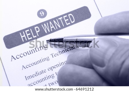 Help Wanted Classified Advertising with Human Hand Holding Silver Pen