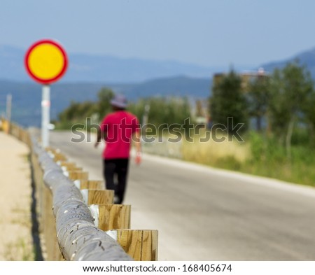 Young man walking on a country road