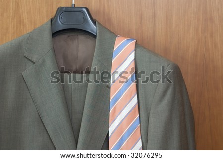 Suit and tie inside of a closet