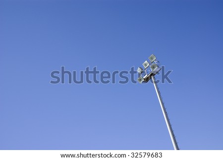 Sports light tower isolated on a blue sky