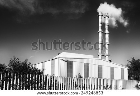 Factory with smoke from pipes