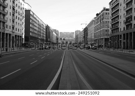 MILAN - JANUARY 28: View of Milan street wit traffic. In Background CENTRALE Train Station in black and White on January 28, 2015 in Milan, Italy.