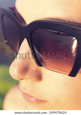 outdoor fashion closeup portrait of young beautiful woman looking at the summer sea waves