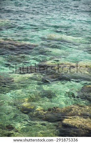 transparent water ripple, marine rocks and sunlight glare. sea bottom wallpaper