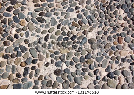 stone wall background or texture with colorful pebbles, concept image of home and garden decorations