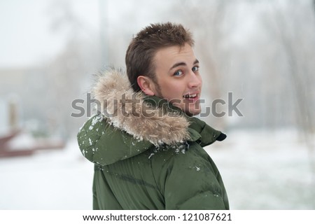 outdoor portrait of young man in green winter jacket
