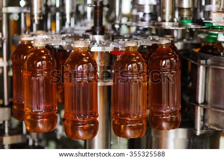 process of bottling on production line