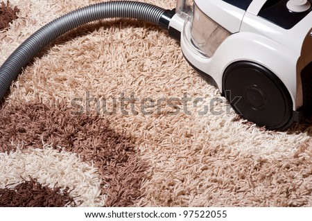 vacuum cleaner on brown carpet