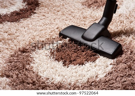 vacuum cleaner on brown carpet