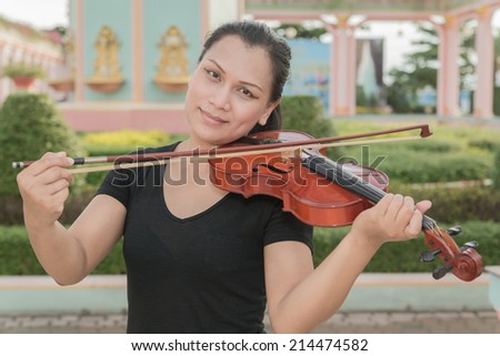 Happy woman play violin.