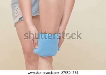 Women using cold-hot pack to relieve pain in the ankle.
