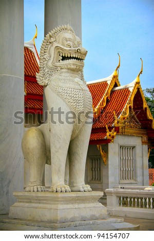 The statue of lion by the entrance to Buddhist temple, Bangkok, Thailand