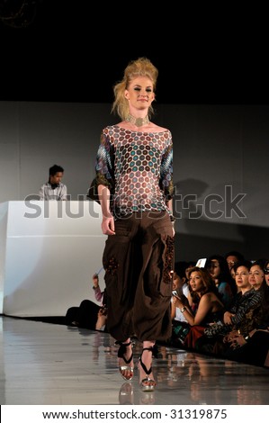 KUALA LUMPUR, MALAYSIA-APRIL 2:Model displays creation by Tom Abang Saufi during STYLO Fashion Show April 2, 2009 in Kuala Lumpur.The fashion show was held in conjunction with Malaysian F1 Grand Prix