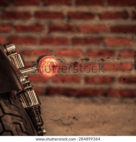 Turn signal motorcycle classic on grunge background.