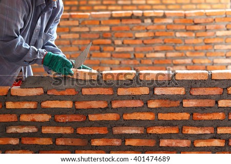 Workers masonry Clay brick to wall.