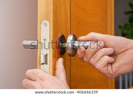 Handyman repairing a door handle
