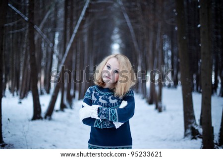 A portrait of young woman in winter forest