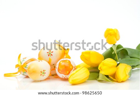 Easter painted eggs with yellow tulips on white