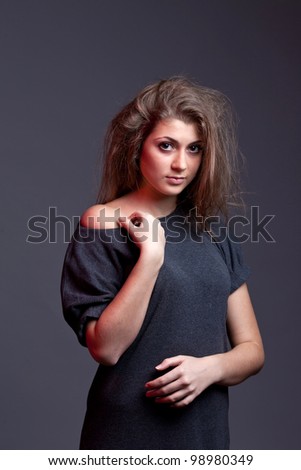 An image of a young woman with messy hair