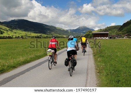 Group of cyclists riding along the cycle path in the Austrian Alps