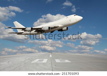 Large white plane without landing gear flies through over the runway