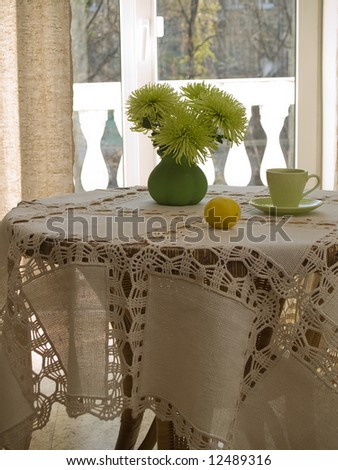 Table with table-cloth in interior in sunny day