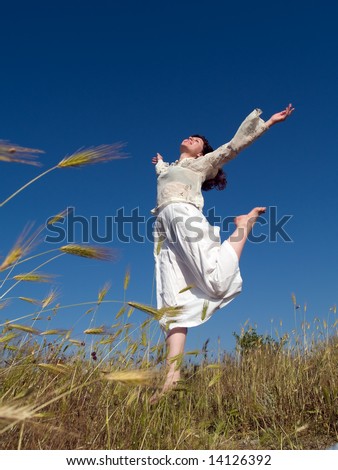 happy young lady runs across the field