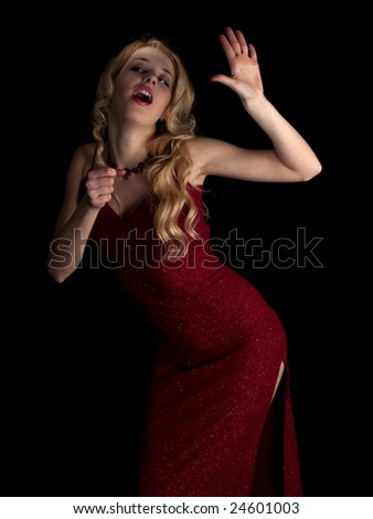 Beautiful blonde young lady in red dress singing