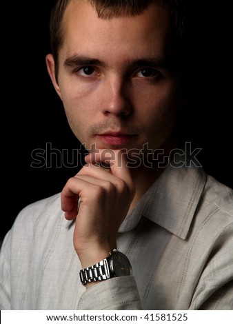 Young man thinking black background isolated portrait