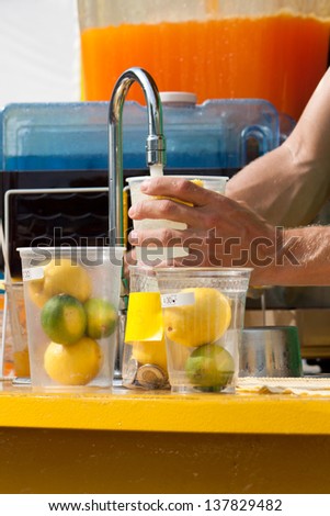 Making lemonade at commercial summer outdoor lemonade stand