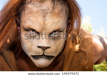 Close -up and meancing face of a Lion man looking into the camera. Fantastic special FX make up of Rayce Bird.