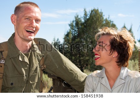 A World War II American soldier shares a happy moment with a Military nurse.  Both wear the actual historical uniforms.