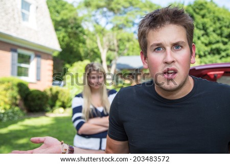 A young man in an argument with his wife, looks to the camera audience for support