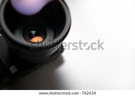 camera with lens in focus on white