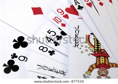 standard playing cards with a joker card focused