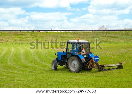 tractor, working on cutting grass in rural areas
