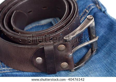 jeans and leather strap. isolated on white