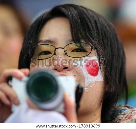 Sochi, RUSSIA - February 13, 2014: Japanese spectators at figure skating competition of men in short program at Sochi 2014 XXII Olympic Winter Games