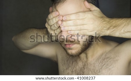 white bearded man closing his eyes with hands