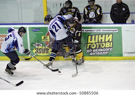 KHARKIV, UKRAINE - APRIL 9: Ponomar (L) takes puck during HC Kharkov vs. HSK Beliy Bars (6:3) ice hockey match, April 9, 2010 in Kharkov, Ukraine