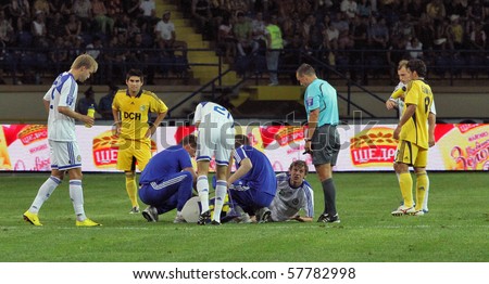 KHARKIV, UKRAINE - JULY 23: Unidentified players being attended by medical personnel during FC Metalist Kharkiv vs. FC Dynamo Kyiv (1:2) football match, July 23, 2010 in Kharkov, Ukraine