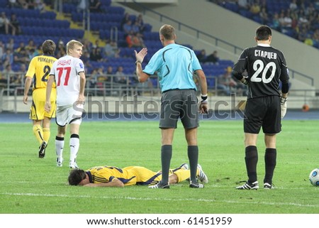 KHARKIV, UKRAINE - AUGUST 22: FC Metalist Kharkiv DF Milan Obradovic downed during football match vs. FC Krivbass Krivoy Rog, August 22, 2010 in Kharkov, Ukraine