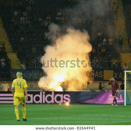 KHARKIV, UA - AUGUST 10: Ukrainian fans burn fireworks during Ukraine - Sweden (0:1) national teams friendly football match, August 10, 2011 in Kharkov, Ukraine